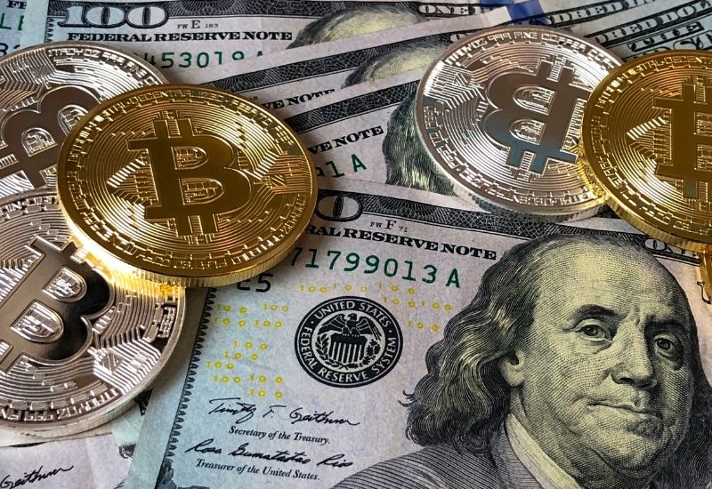 Bitcoins above Dollar Bills
