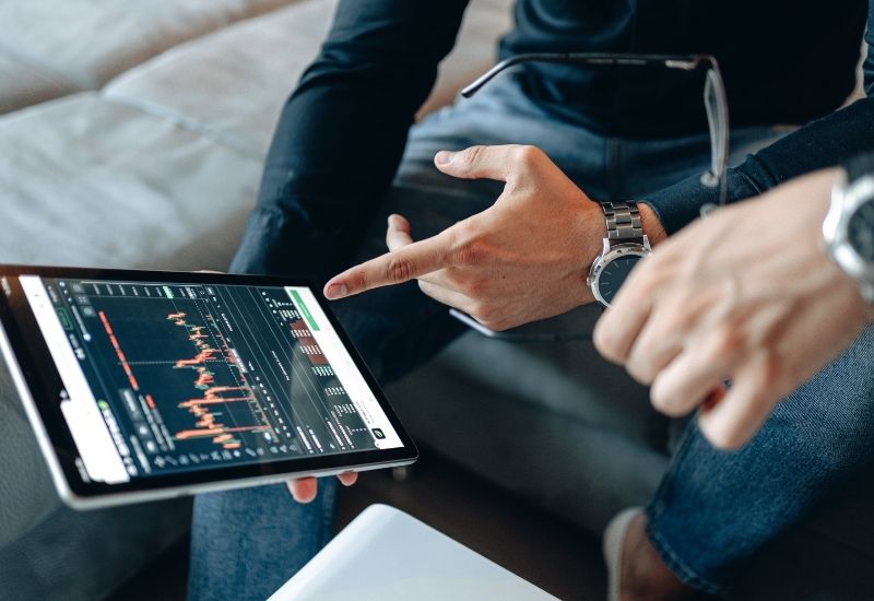 Investors in front of Crypto Trading Graphic