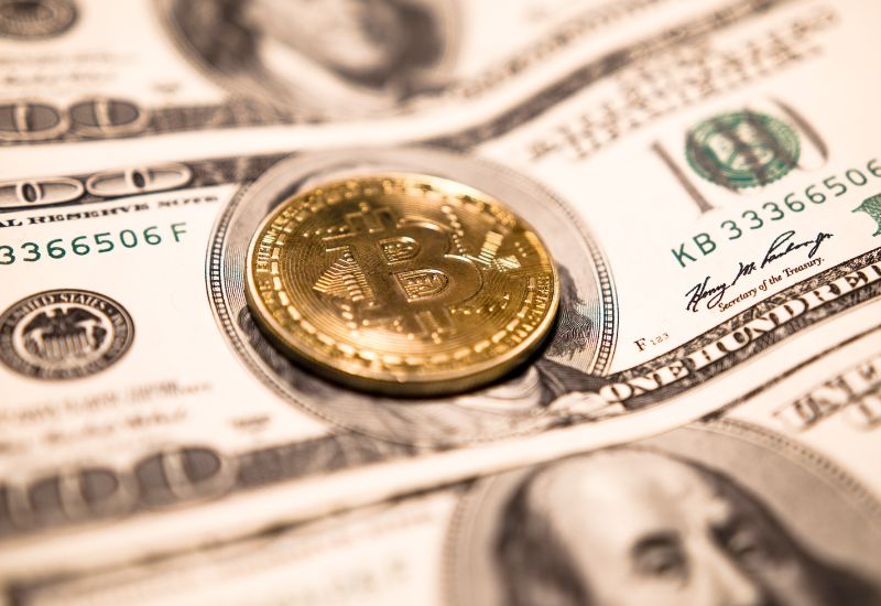 Bitcoin above dollar bill