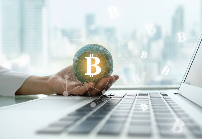 Small Globe with Bitcoin Symbol on Hand