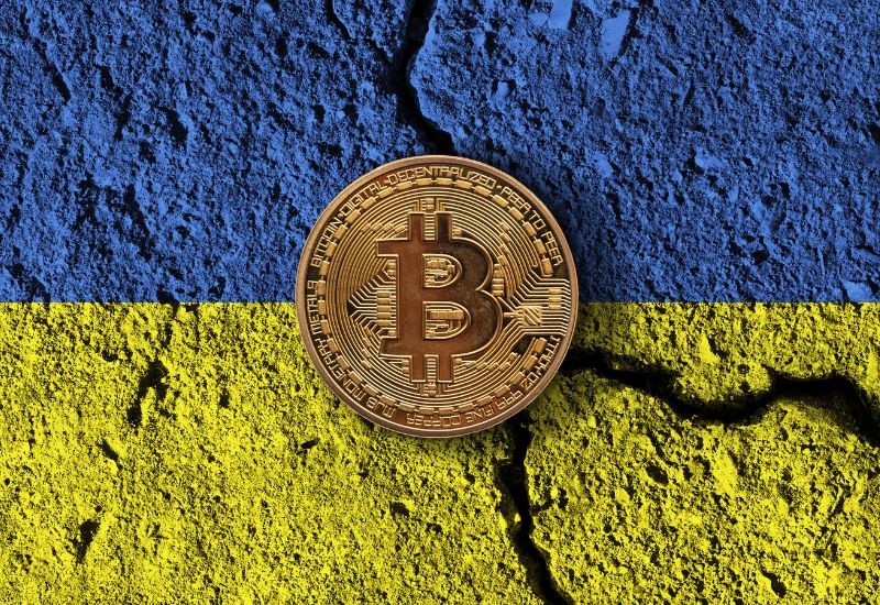 Bitcoin above a blue and yellow surface