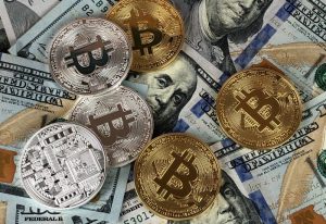 Golden Silver Bitcoins above dollar bills